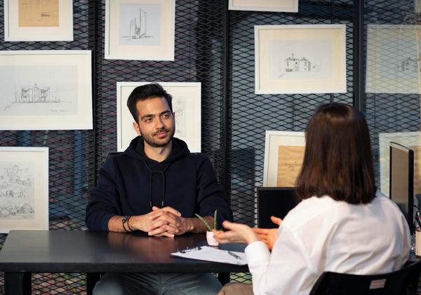 2 people interviewing at a table