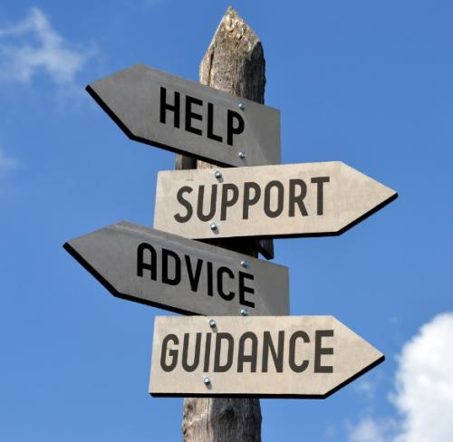 A sign post with directional signs reading "Help, Support, Advice and Guidance"