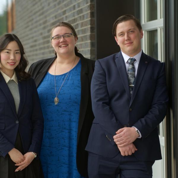 Three MBA internship students posing outside the 2019 Multicultural Tea