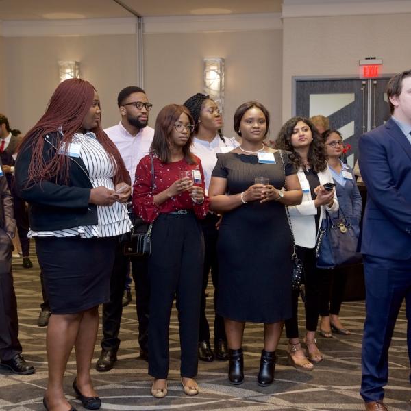 MBA internship students watching their peers present their PechaKucha at the 2019 Business Mixer at the Coast Bastion Hotel