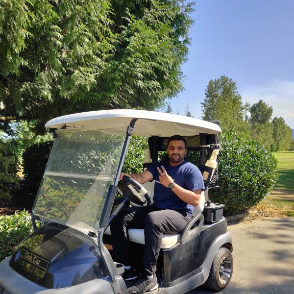 Shaurya Ahuja driving a golf cart at the Chamber of Commerce Golf Tournament