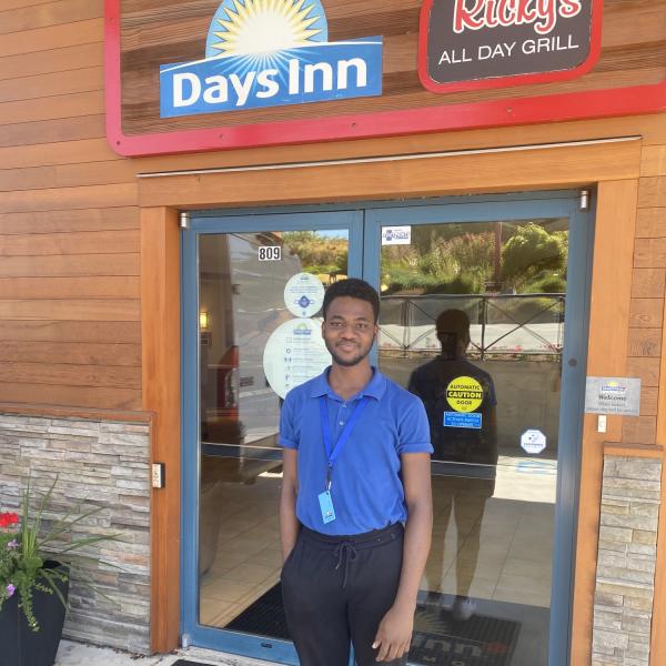 WIL Student Standing in front of Days Inn