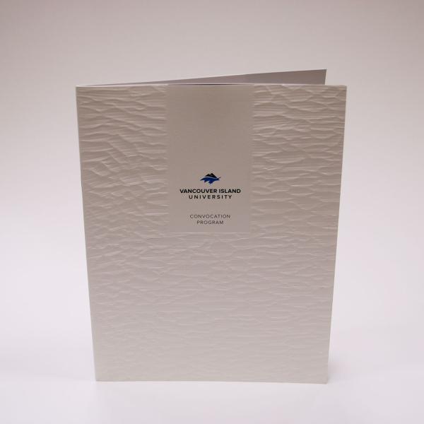 A convocation brochure on embossed paper.