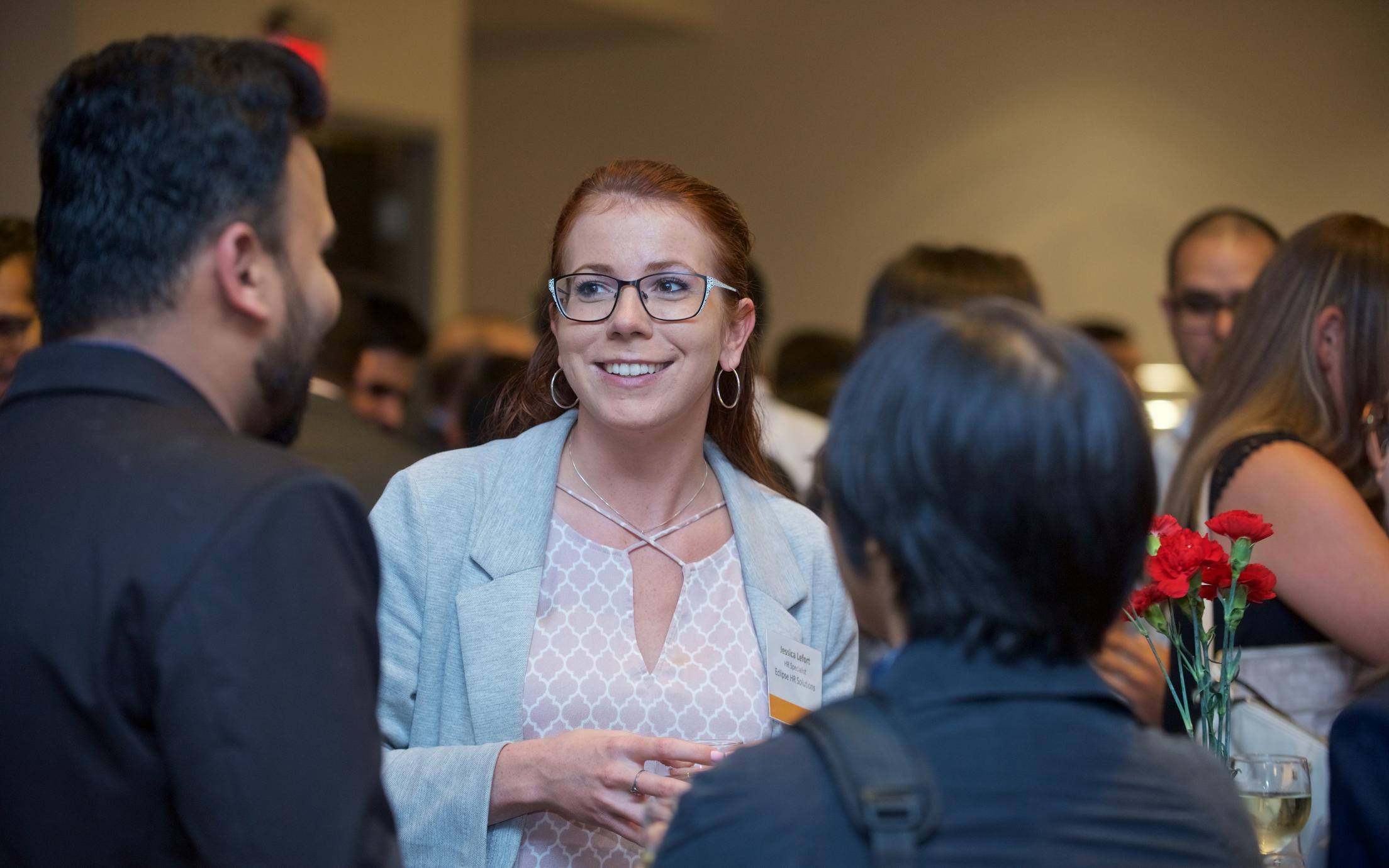 An employer talking to students at an MBA networking event