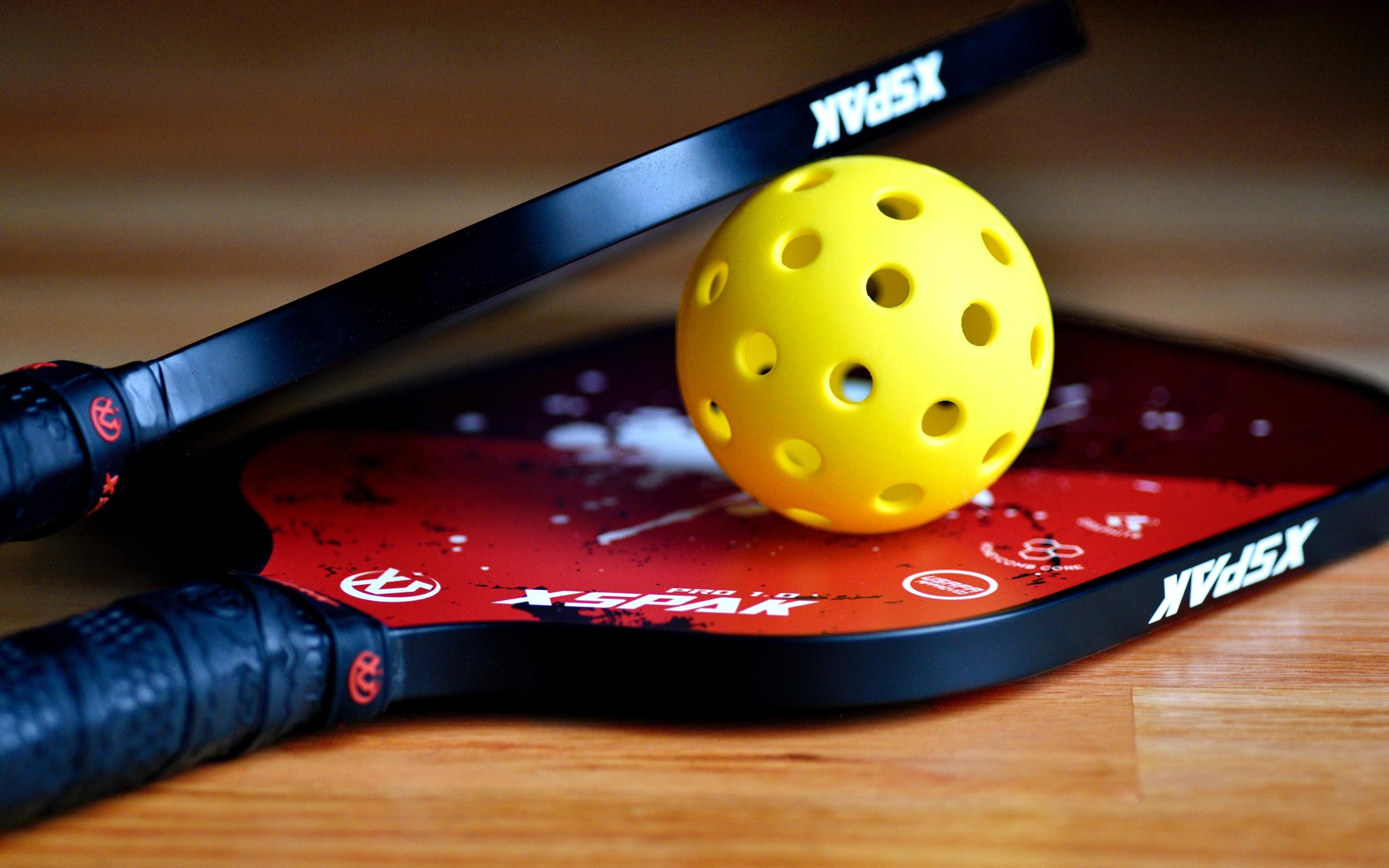 PIckleball racquets and ball - photo by Ben Hershey / Unsplash