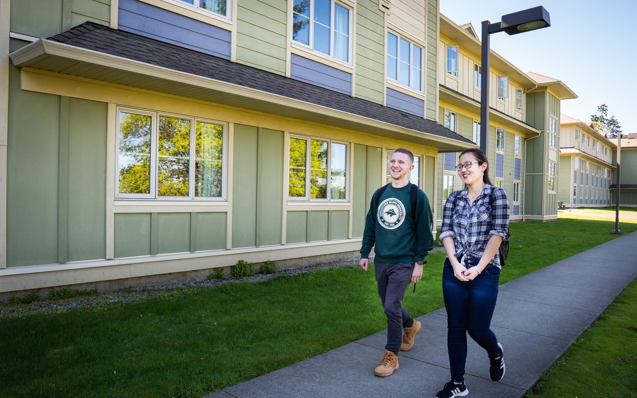 Two Students walk by the VIU Residence