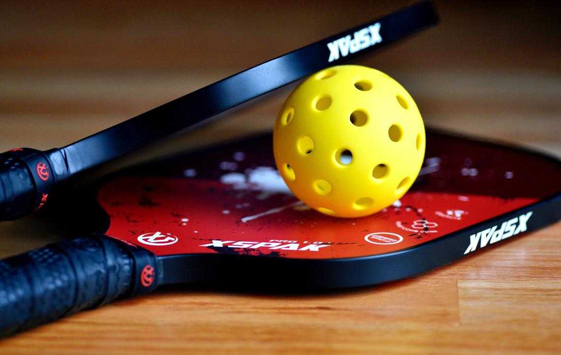 Pickleball racquets and ball - photo by Ben Hershey / Unsplash