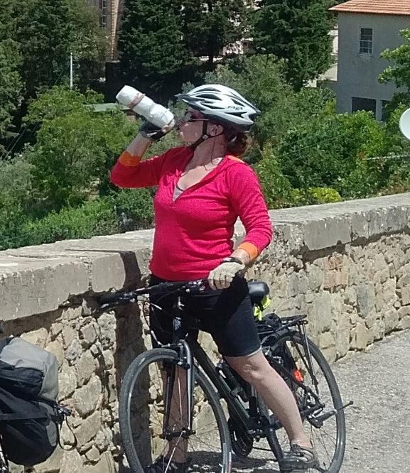 Shirley on a bike drinking from a water bottle