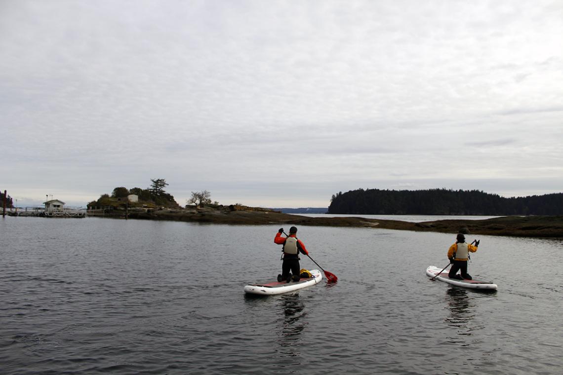 VIU students paddle by Saysutshun, just off the coast of Nanaimo, BC, Canada