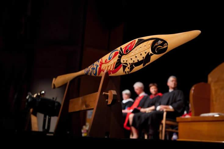 A ceremonial paddle carved and painted in Northwest Coast Indigenous style.