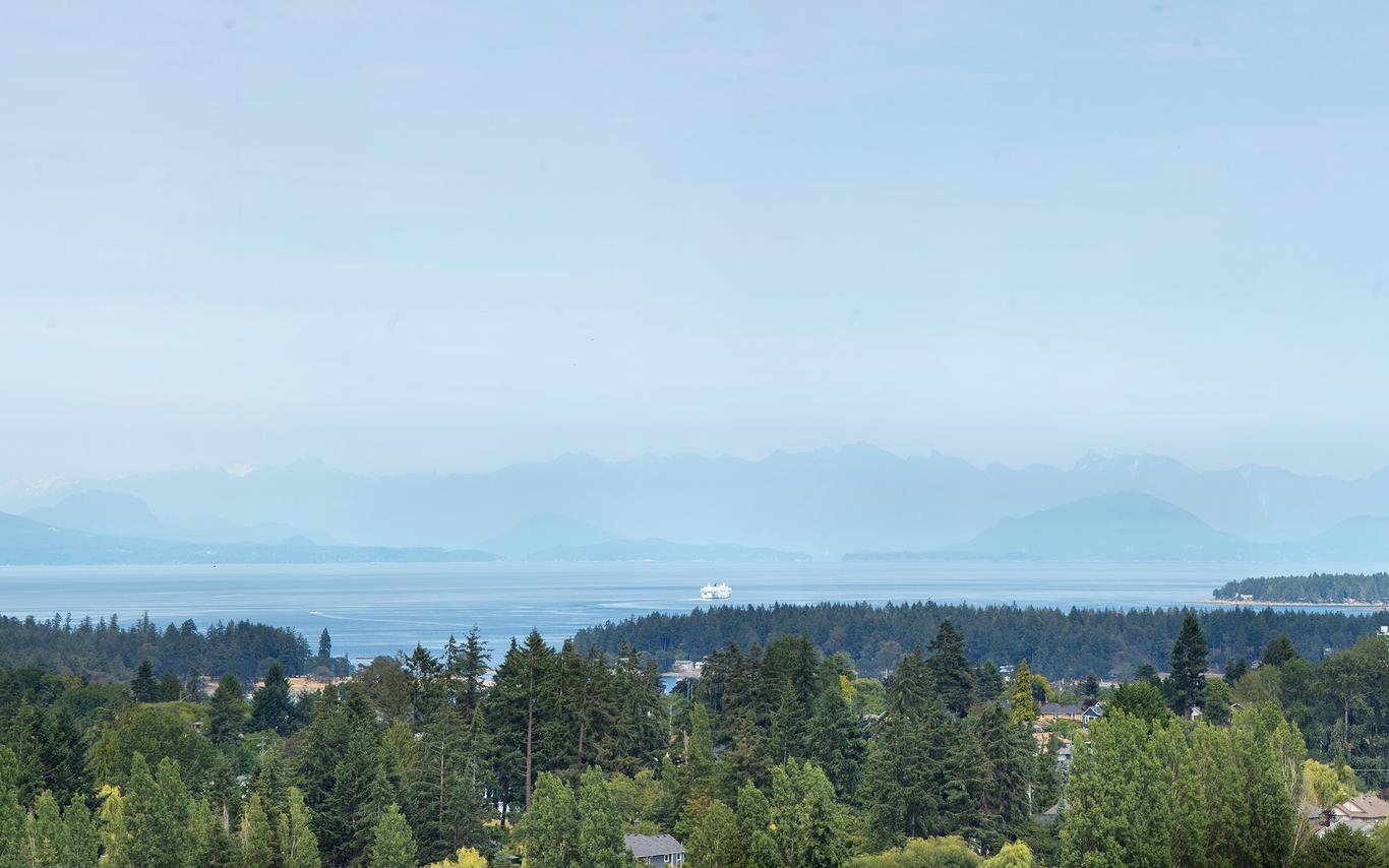 View of oceans and mountains under a blue sky