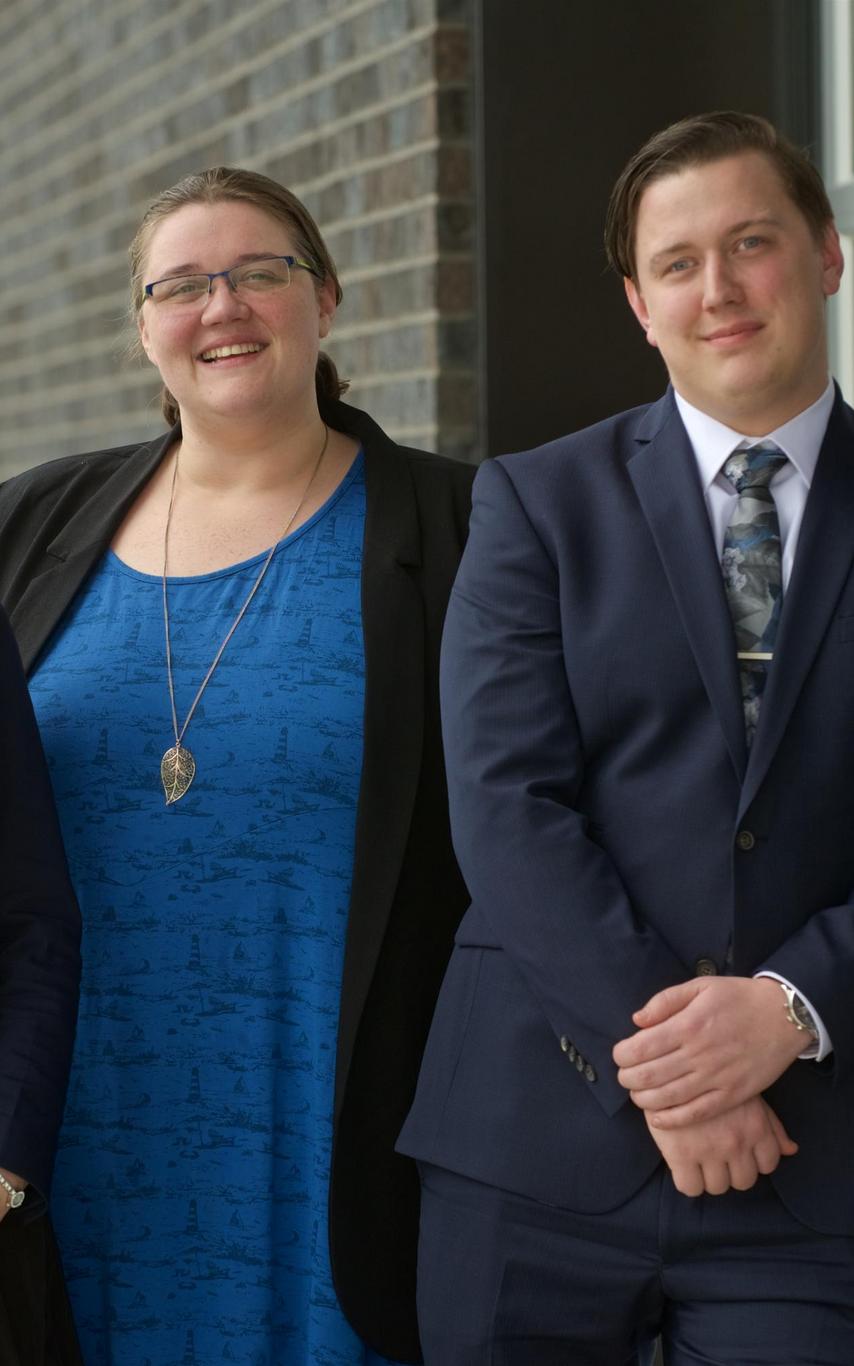 Three MBA internship students posing outside the 2019 Multicultural Tea