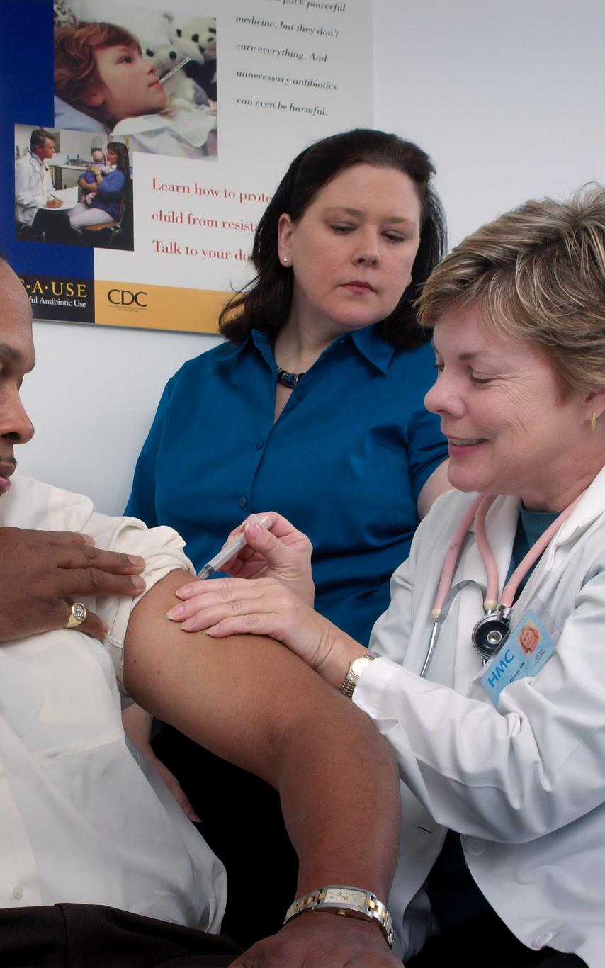 A nurse giving a man a shot