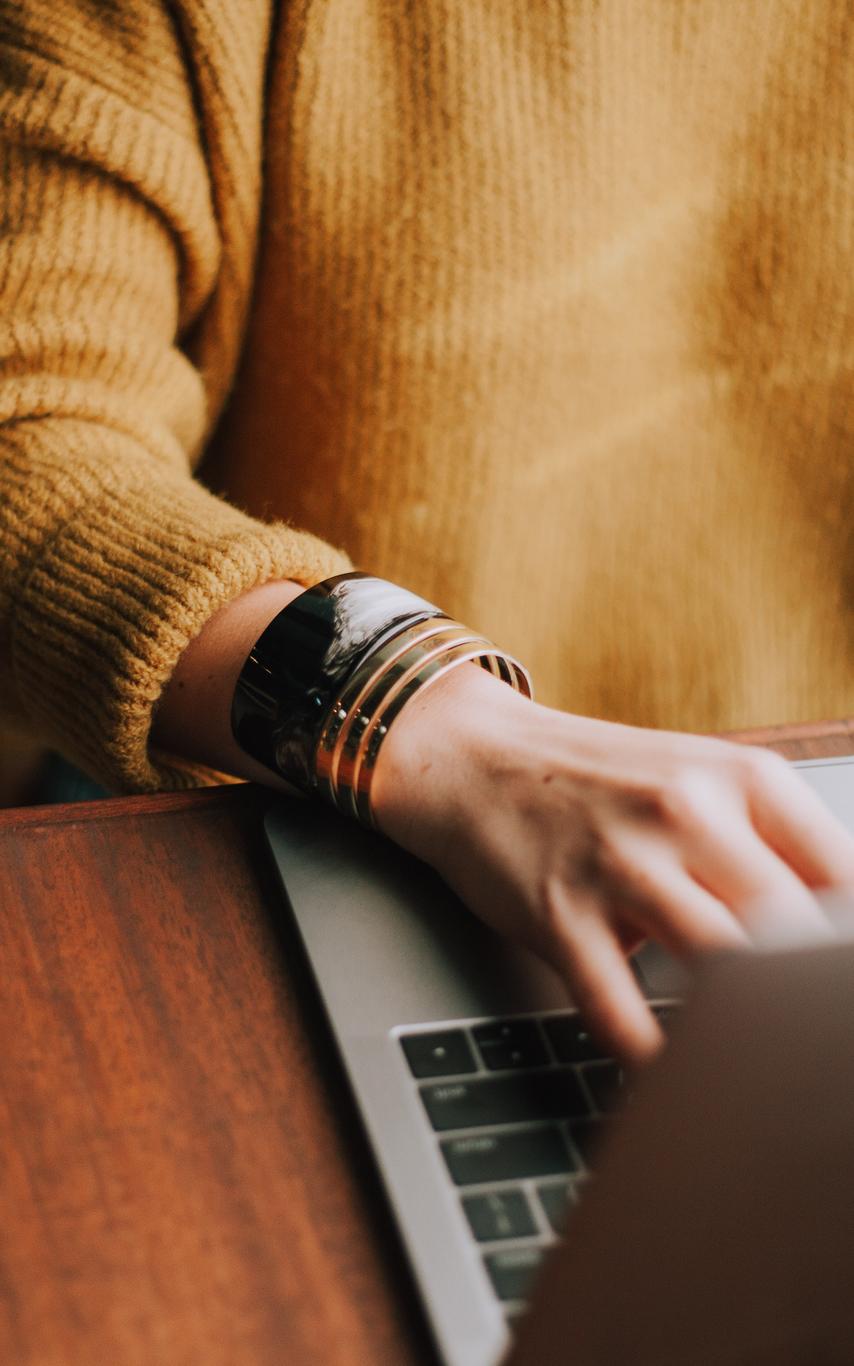 A person typing on a laptop