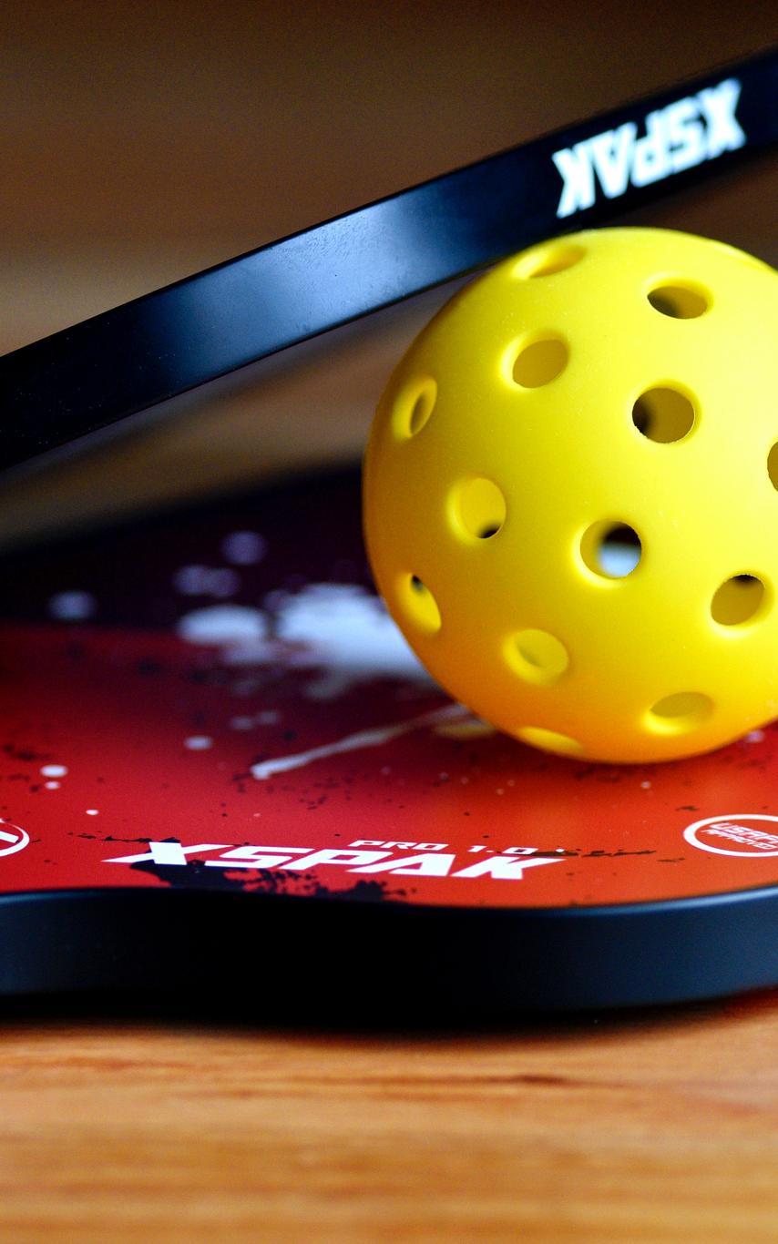 PIckleball racquets and ball - photo by Ben Hershey / Unsplash